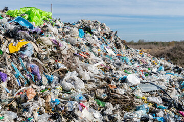 Huge pile of trash and plastic waste at landfill site, environmental pollution and waste management...