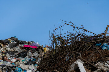 Landfill of Debris Against a Blue Sky, Pollution and Waste Material Creating Ecological Issues,...