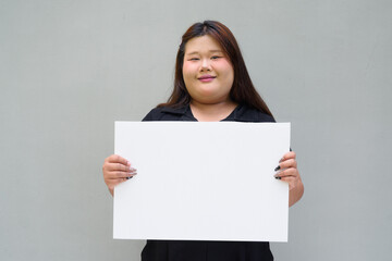 young woman holding a blank white board