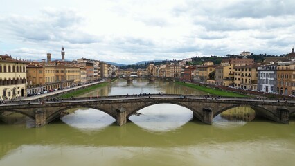 Obraz premium Europe, Italy, Florence , drone aerial view of Florence and Arno river - the Old Bridge , Ponte Vecchio , in city downtown of the Middle Ages and Renaissance art - Tourist attraction destination 