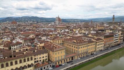 Europe, Italy, Florence , drone aerial view of Florence and Arno river - the Old Bridge , Ponte Vecchio , in city downtown  of the Middle Ages and Renaissance art - Tourist attraction destination 