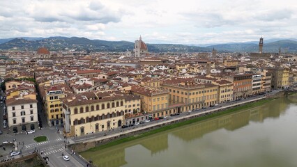 Europe, Italy, Florence , drone aerial view of Florence and Arno river - the Old Bridge , Ponte Vecchio , in city downtown  of the Middle Ages and Renaissance art - Tourist attraction destination 