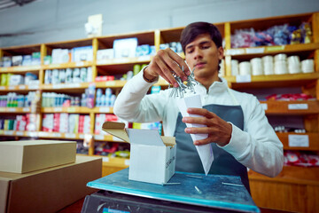 Worker sorting keys at a hardware store counter