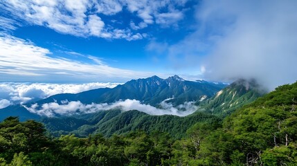 Obraz premium Majestic mountain range viewed from above, showcasing lush green forests, dramatic peaks, and a sea of clouds under a vibrant blue sky. The scene evokes a sense of serenity and natura : Generative AI
