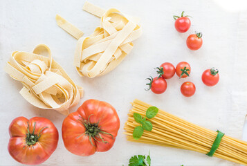 Pasta and spaghetti with tomatoes for preparing a healthy dish with tomatoes. Top view.