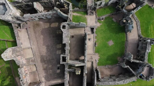 Raglan Castle ruins Wales medieval fortress aerial view farmland fields captured by drone in 4K