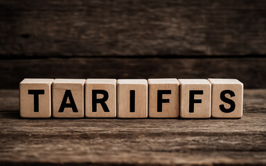 Fototapeta premium Tariffs word written on wooden cubes on wooden table