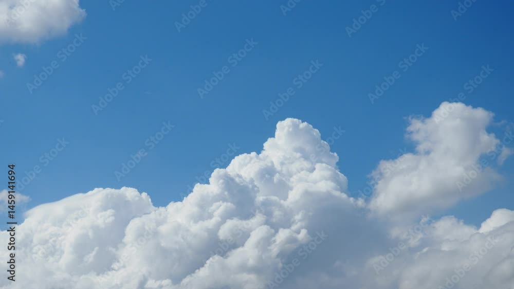 Poster A spectacular display of beautiful clouds floats effortlessly in a vast blue expanse, creating a peaceful atmosphere