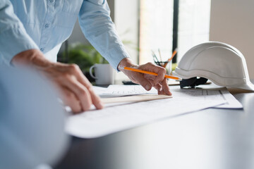 Close up of mature woman architect blueprint planning and design for vision or project. Female...