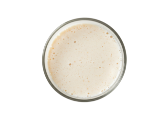 Creamy white drink fills glass with bubbles viewed from above