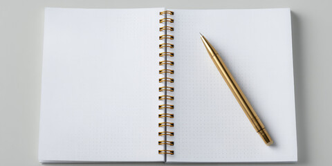 Open notebook with a spiral binding and a gold pen resting on its pages. Writing inspiration, stationery
