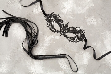 Set of erotic BDSM accessories on concrete background, top view