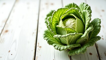 Fresh green cabbage, a healthy organic vegetable ingredient, rests on a rustic wooden table