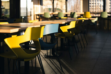 Interior of an empty cafe in the morning with sunlight and shadows.