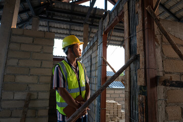 Inspector engineer man working with tablet computer on construction site interior