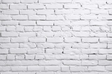 A white-painted brick wall with a clean, textured surface and visible mortar lines.