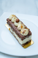 Rich chocolate and vanilla layers make a luscious dessert, topped with nut pieces