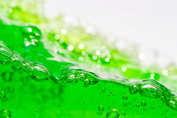 Water wave, close up of vibrant green liquid with bubbles, capturing dynamic movement and...