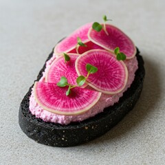 Artistic Radish Tartine on Charcoal Bread with Beet Goat Cheese