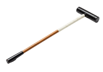 A vintage croquet mallet rests in the dark revealing wood grain and wrapped handle details