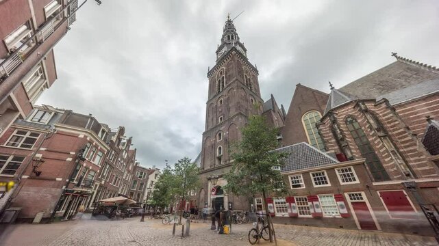 Hyperlapse of Amsterdam's Old Church (Oude Kerk), the city's oldest parish church, surrounded by historical houses in De Wallen district on Oudekerksplein timelapse. Iconic landmark in the Netherlands