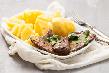 Fried Liver with boiled potato on plate