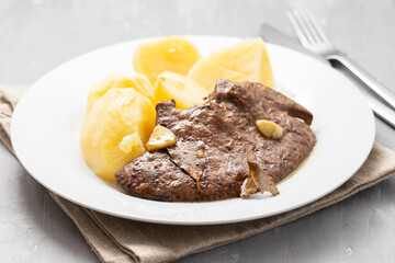 Fried Liver with boiled potato on plate