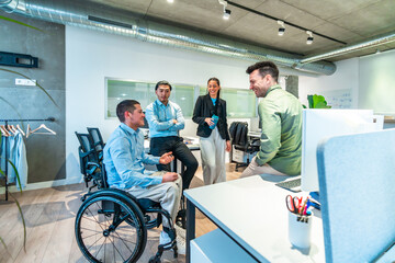 Diverse business team collaborating in modern office, wheelchair user leading discussion