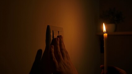 Hand Approaching Light Switch During Power Outage