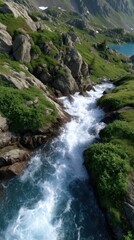 Obraz premium Mountain stream cascades through a rugged landscape with boulders and lush green vegetation flowing towards turquoise alpine lake