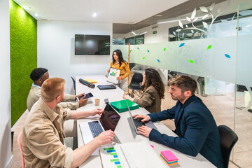 Marketing professionals collaborating on project in modern office