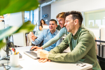 Software developers working together on a project in modern office