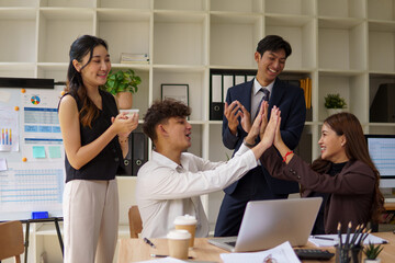 Cheerful  business team  congratulating each other after a successful meeting.