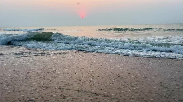 Wave breaking on sea shore in a quiet and calm of morning sunrise atmosphere.