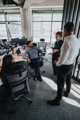 Group of business people in a modern office setting engage in a productive discussion. The team...