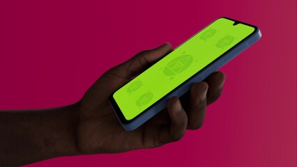 Black African-American middle aged male using smartphone with a blank green screen. Mobile app video mockup. Vertical phone orientation