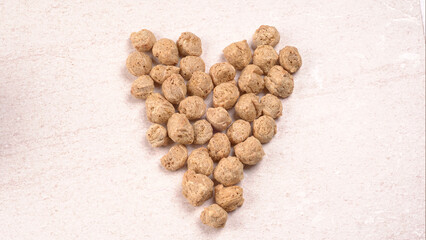 Raw soya chunks on dark background. Healthy, nutritious soybean meat, chunks isolated.Vegan food...