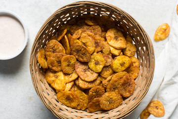 Overhead view of fried plantains on a white countertop, top view of fried ripe plantains on a white background