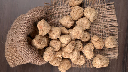 Raw soya chunks on dark background. Healthy, nutritious soybean meat, chunks isolated.Vegan food concept.