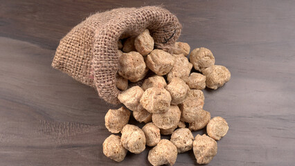 Raw soya chunks on dark background. Healthy, nutritious soybean meat, chunks isolated.Vegan food concept.