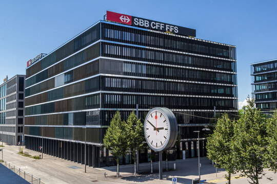 Wankdorf, Switzerland - July 10. 2021: The headquarter of the Swiss state-run railway company SBB, or CFF, or FFS. The huge digital clock smybolizes puncuality of Swiss train transportation.