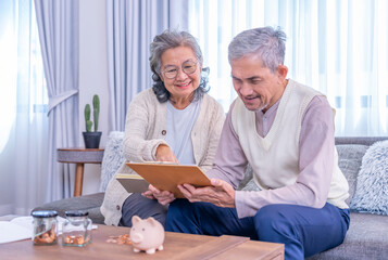 asian senior couple looking for savings plan together,elderly lifestyle,money management,saving...