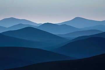 Misty mountain range, soft blue tones.  Layers of peaks fade into the distance