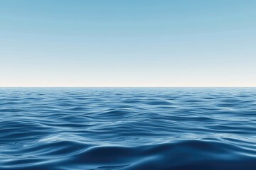 Calm ocean surface, vast expanse of deep blue water meeting a clear, light blue sky