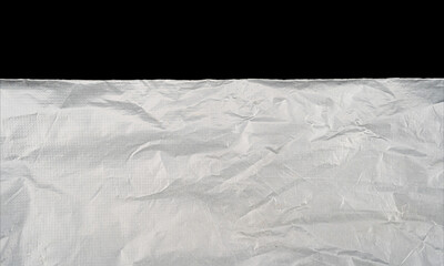 Textured white crumpled paper on a black backdrop.
