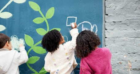 Wall, students and drawing with chalk for education, cognitive development and creativity in school. Back, group and children with learning for writing mural, inspiration and outdoor in kindergarten © CineLens25/peopleimages.com