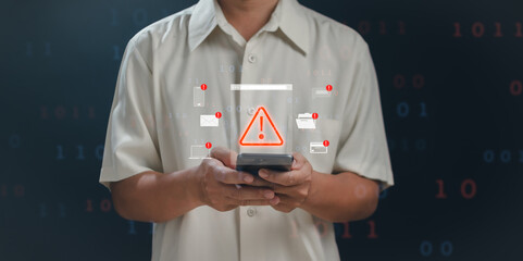 Concept of warning or alert, technology scam, technology crime, Man using mobile phone displaying warning about access to software, virus, dangerous cyber attack or online network hacking threat