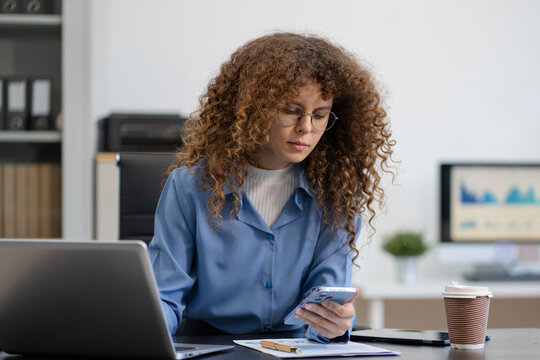 Business woman hand Project manager working and update tasks and Gantt chart scheduling virtual diagram.with smart phone, tablet and laptop in office.