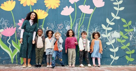 Teacher, children and mural on school wall for creative education, chalk drawing or sustainable awareness. Portrait, people and kid students by floral painting for earth day art lesson or development © CineLens25/peopleimages.com
