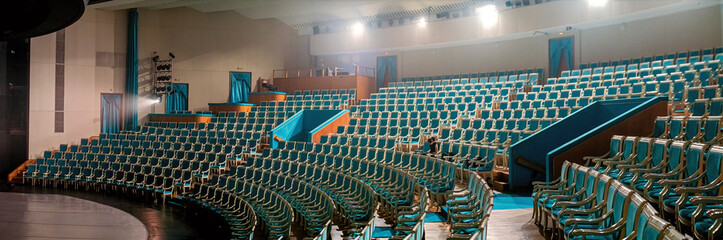 Empty Theater with Rows of Blue Seats and Stage